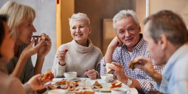 Elderly Residents Enjoying Social Dining Experience at Independent Living Facility