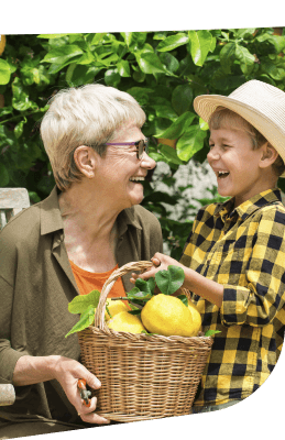 Elderly Woman and Young Boy Holding Basket of Lemons at Independent Living Elderly Woman and Young Boy Holding Basket of Lemons at Independent Living