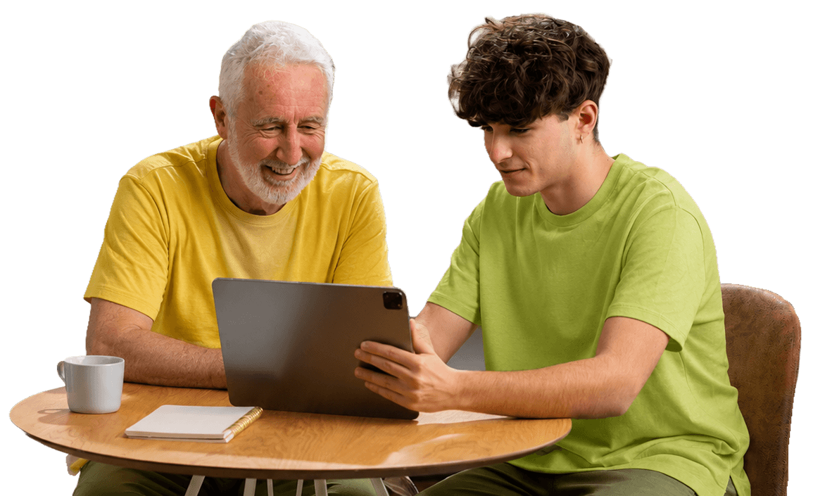 Smiling Elderly Man Viewing a Tablet with Young Visitor at Independent Living Facility