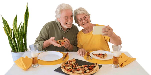 Elderly Couple Taking a Selfie While Enjoying Homemade Pizza at an Independent Living Facility Elderly Couple Taking a Selfie While Enjoying Homemade Pizza at an Independent Living Facility