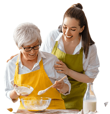 Elderly Woman and Younger Woman Baking Together in the Kitchen at an Independent Living Community Elderly Woman and Younger Woman Baking Together in the Kitchen at an Independent Living Community