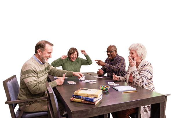Four Elderly Friends Laughing and Pointing While Playing Cards at an Independent Living Facility Four Elderly Friends Laughing and Pointing While Playing Cards at an Independent Living Facility