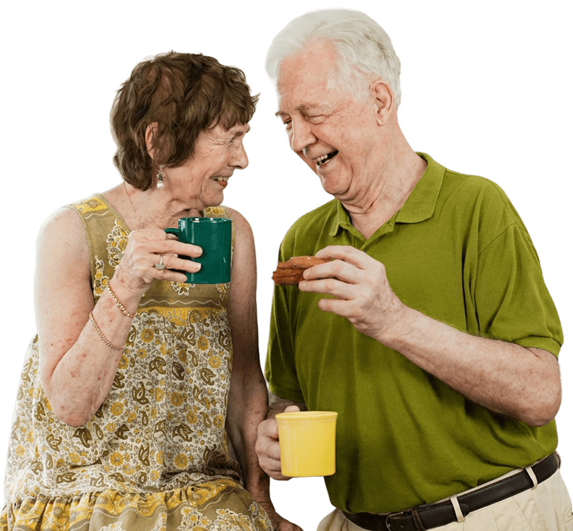 Elderly Couple Laughing While Enjoying Coffee and Cookies Together at an Independent Living Facility Elderly Couple Laughing While Enjoying Coffee and Cookies Together at an Independent Living Facility