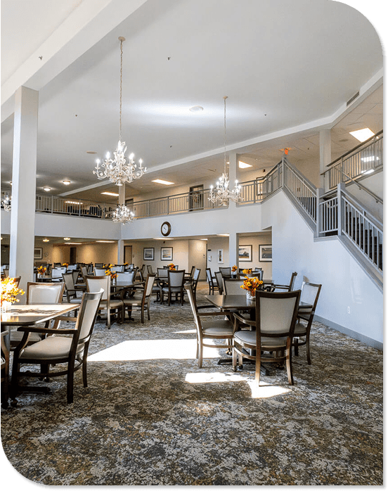 Elegant Dining Room with Chandeliers and Set Tables at an Independent Living Community Elegant Dining Room with Chandeliers and Set Tables at an Independent Living Community