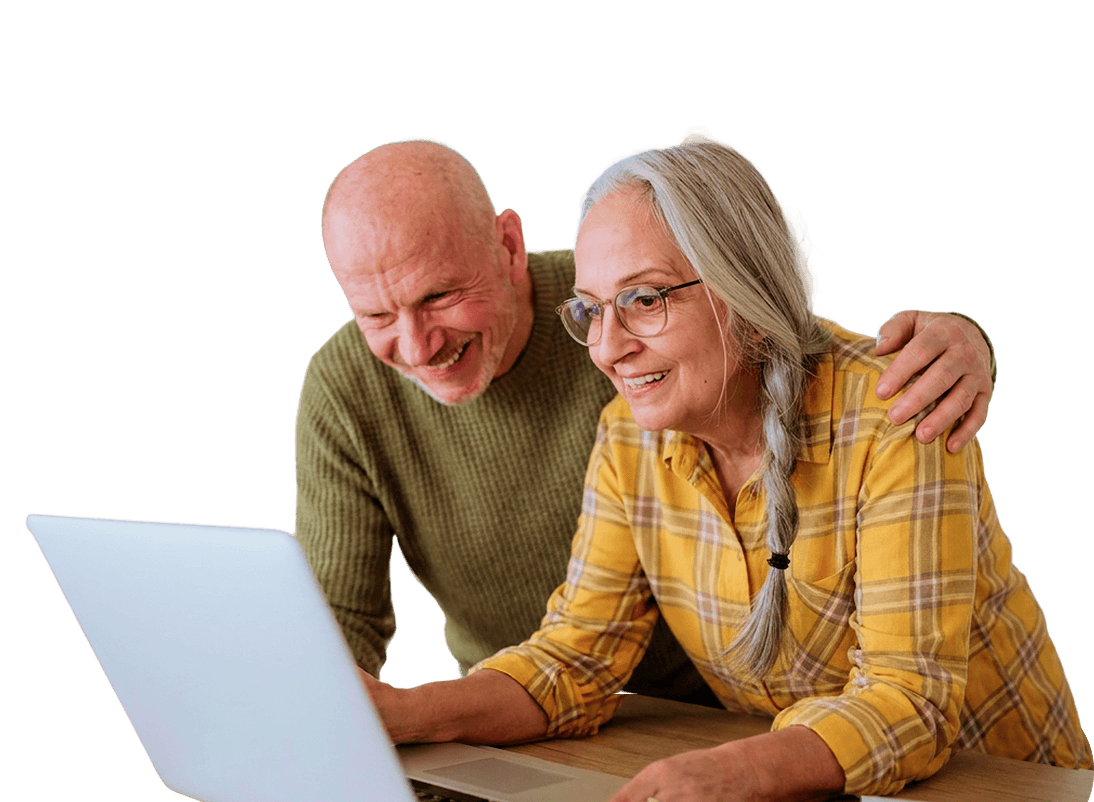 Smiling Elderly Couple Looking at a Laptop Screen Together at an Independent Living Community Smiling Elderly Couple Looking at a Laptop Screen Together at an Independent Living Community