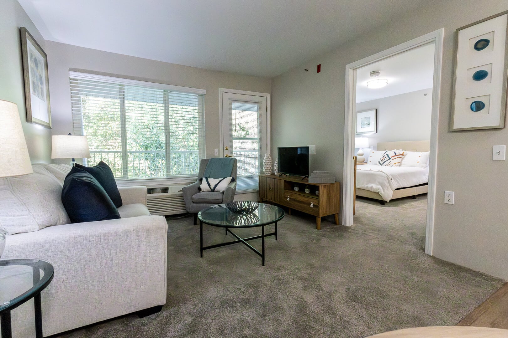 Open-Concept Furnished Apartment with Living Room and Bedroom at an Independent Living Community