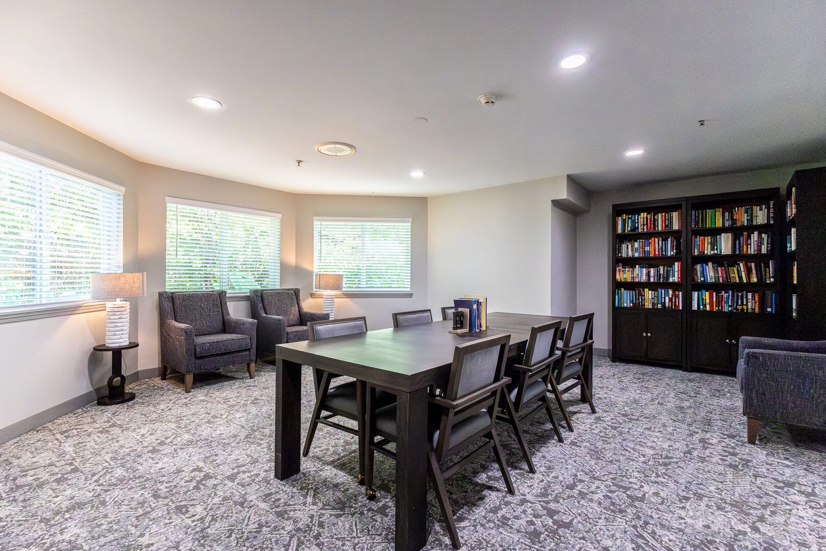 Cozy Reading Library with Bookshelves and Dining Table for Residents in Independent Living