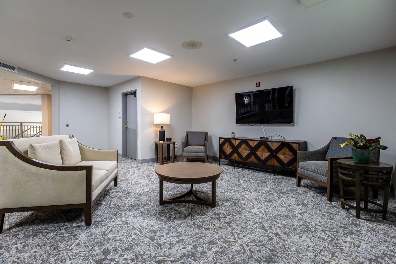 Comfortable TV Lounge with Sofa and Accent Chairs at an Independent Living Community
