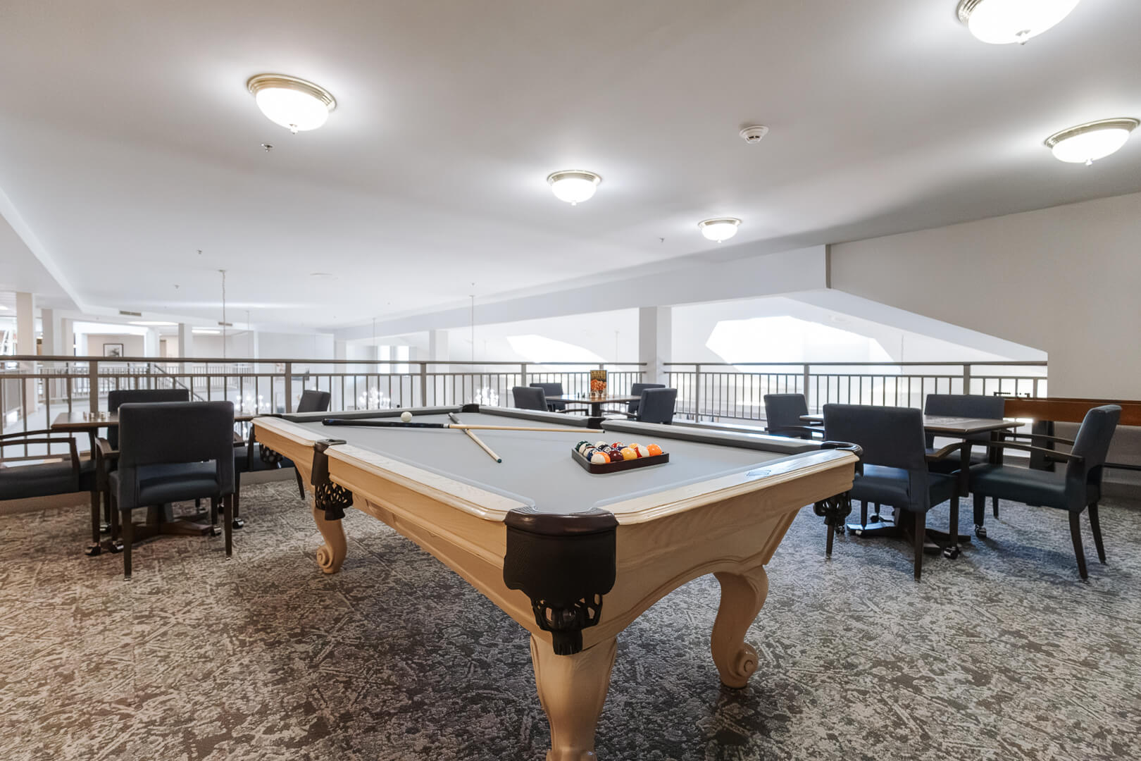 Spacious Billiards Room with Pool Table and Café Seating in an Independent Living Facility