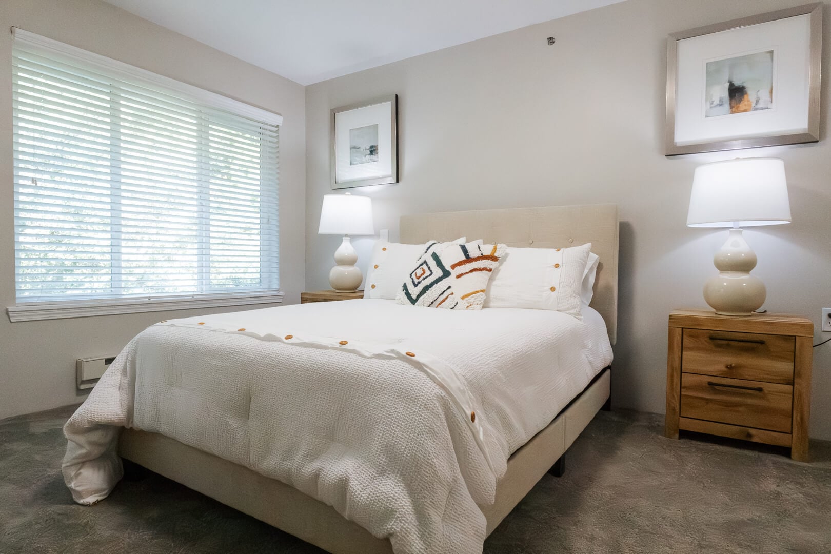 Bright Comfortable Bedroom with Soft Bedding and Bedside Lamps at an Independent Living Facility