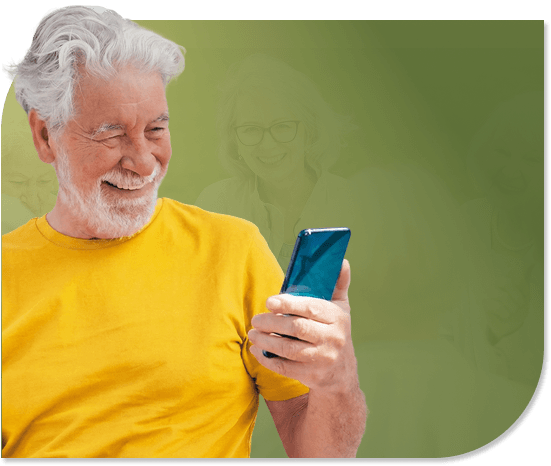 Smiling Elderly Man Looking at His Smartphone Screen at an Independent Living Facility Smiling Elderly Man Looking at His Smartphone Screen at an Independent Living Facility